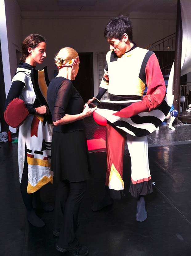 Millicent Hodson checking the Water and Egg Wizard costumes of Valérie Ferrando and Bulat Akhmejanov. © Kenneth Archer. (Click image for larger version)