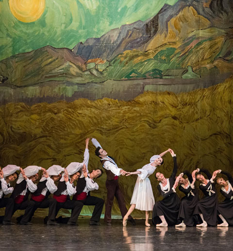 Isabelle Ciaravola as Vivette and Jeremie Belingard as Frederi, with members of Paris Opera Ballet in Roland Petit's <I>L'Arlesienne</I>.<br />© Stephanie Berger. (Click image for larger version)